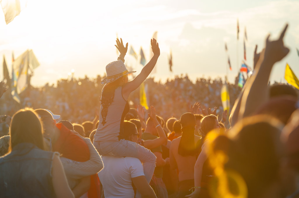 BIG ZAVIDOVO, RUSSIA - JULY 5: People cheering at open-air rock festival "Nashestvie" on July 5, 2014 in Big Zavidovo, Russia. "Nashestvie" is the biggest rock festival in Russia, more 200000 visitors