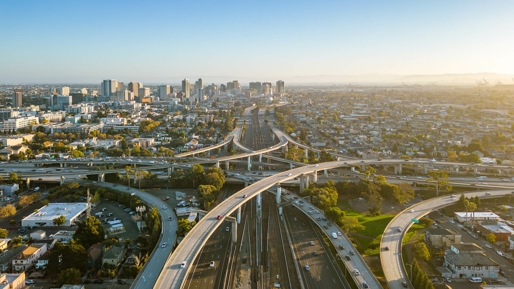 A drone view over the freeway cypress in Oakland, California during sunset with the downtown in the background.