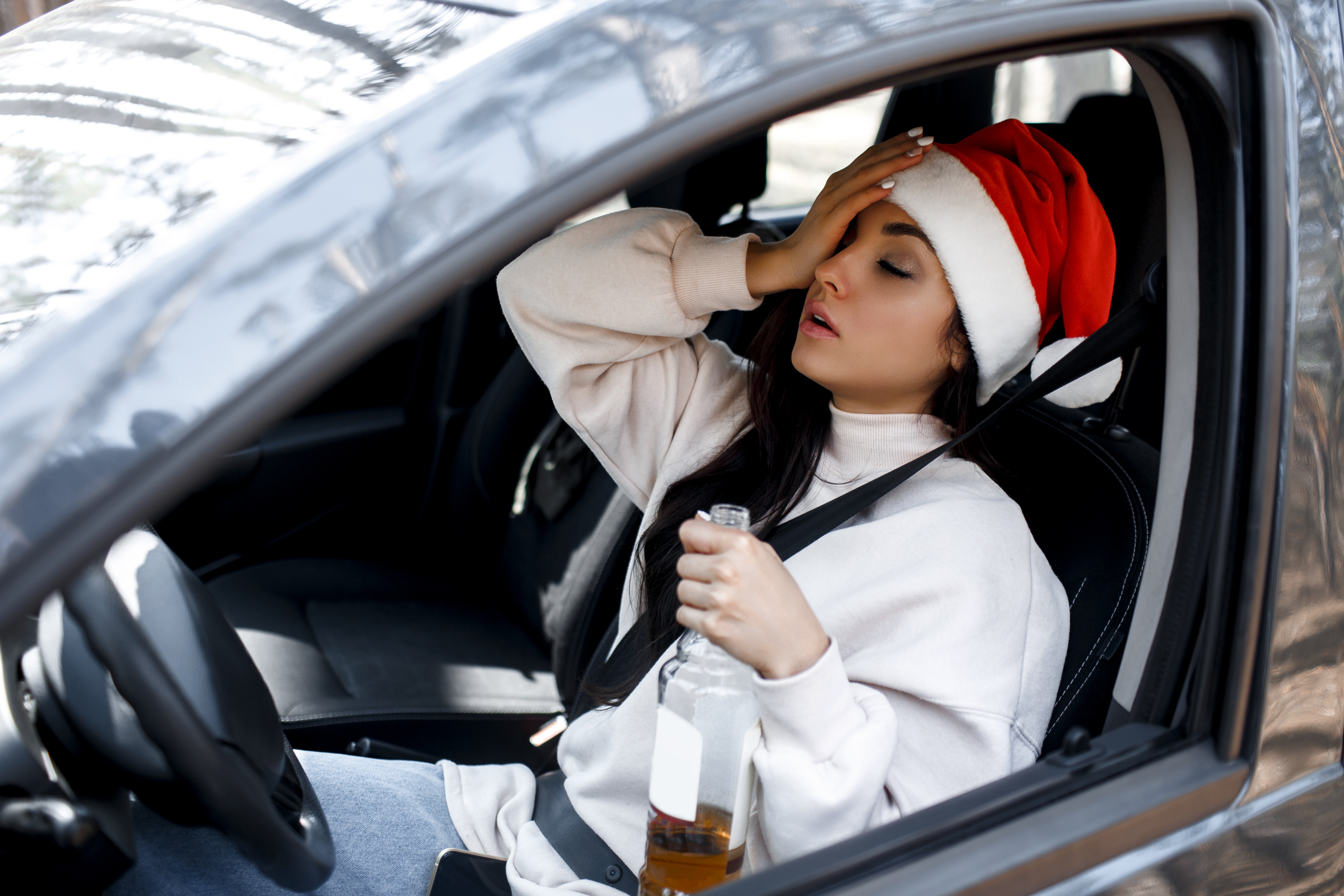 Drinking at the wheel. Drunk woman on new year's eve. You can't drive a car and drink alcohol at Christmas Eve.